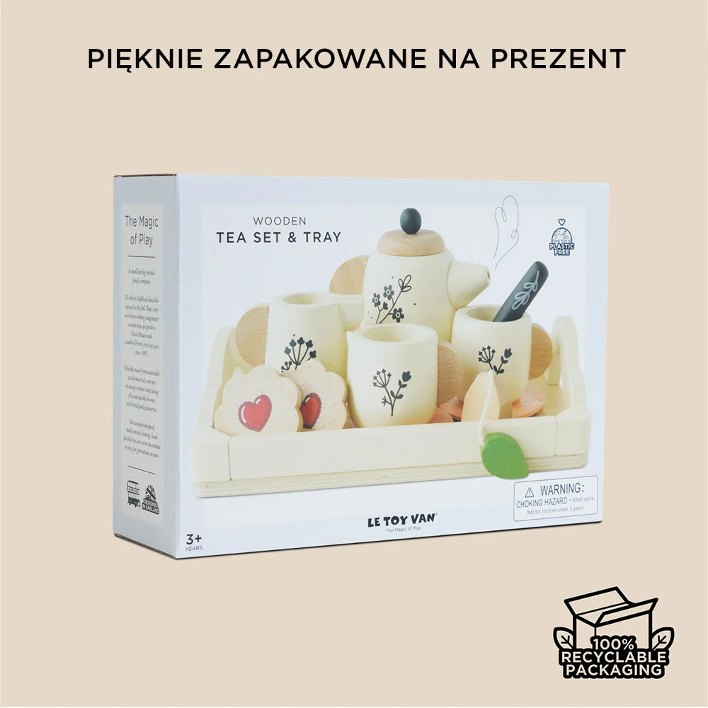Drewniany zestaw do herbaty dla dzieci w brytyjskim stylu, pięknie zapakowany na prezent. Widoczne filiżanki, imbryk i akcesoria kuchenne w złamanej bieli z uroczymi motywami roślinnymi. Opakowanie ekologiczne.
