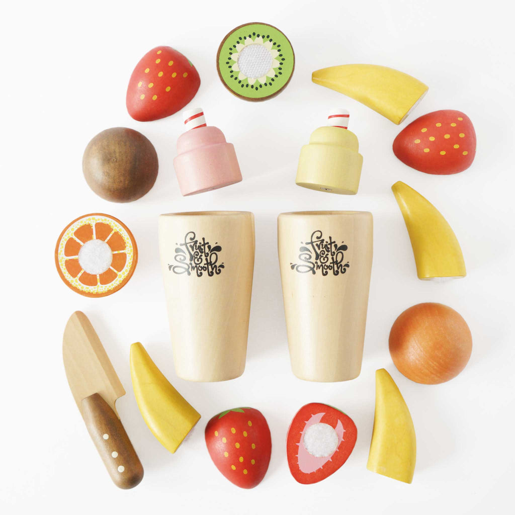 Drewniany zestaw do smoothie Fruit & Smooth: kolorowe owoce na rzepy (truskawki, kiwi, banany, pomarańcze), drewniany nóż i dwa kubki z logo. Idealny do kreatywnej zabawy w krojenie i przygotowywanie zdrowych napojów, rozwijający wyobraźnię i uczący zdrowego żywienia.